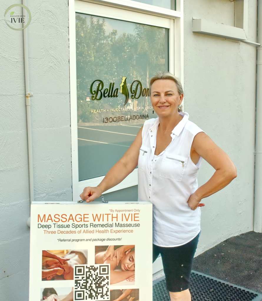 massage therapist ivie standing at the front door in burleigh